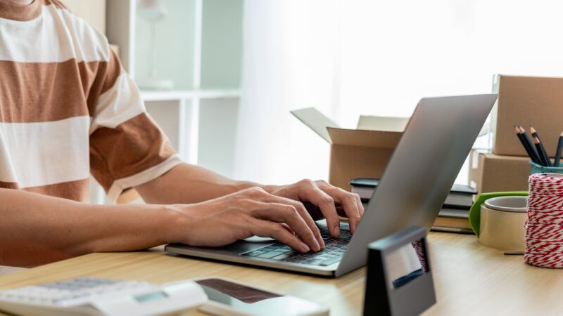 Online shopping concept an online seller typing on his laptop to Online shopping concept an online seller typing on his laptop to